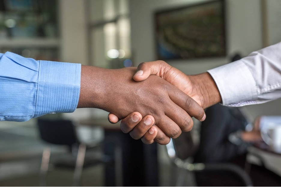 A close-up of two men shaking hands